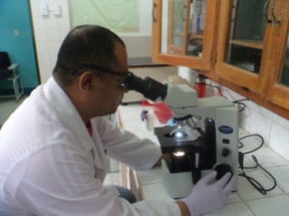 Laboratory director using the new microscope for the first time